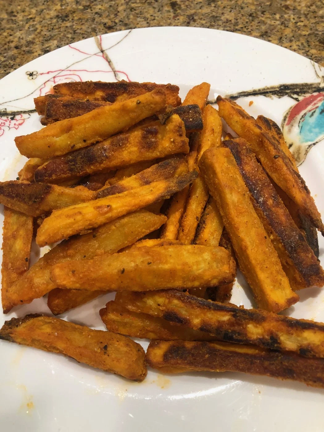 A close view of browned sweet-potato fries with crisp edges.